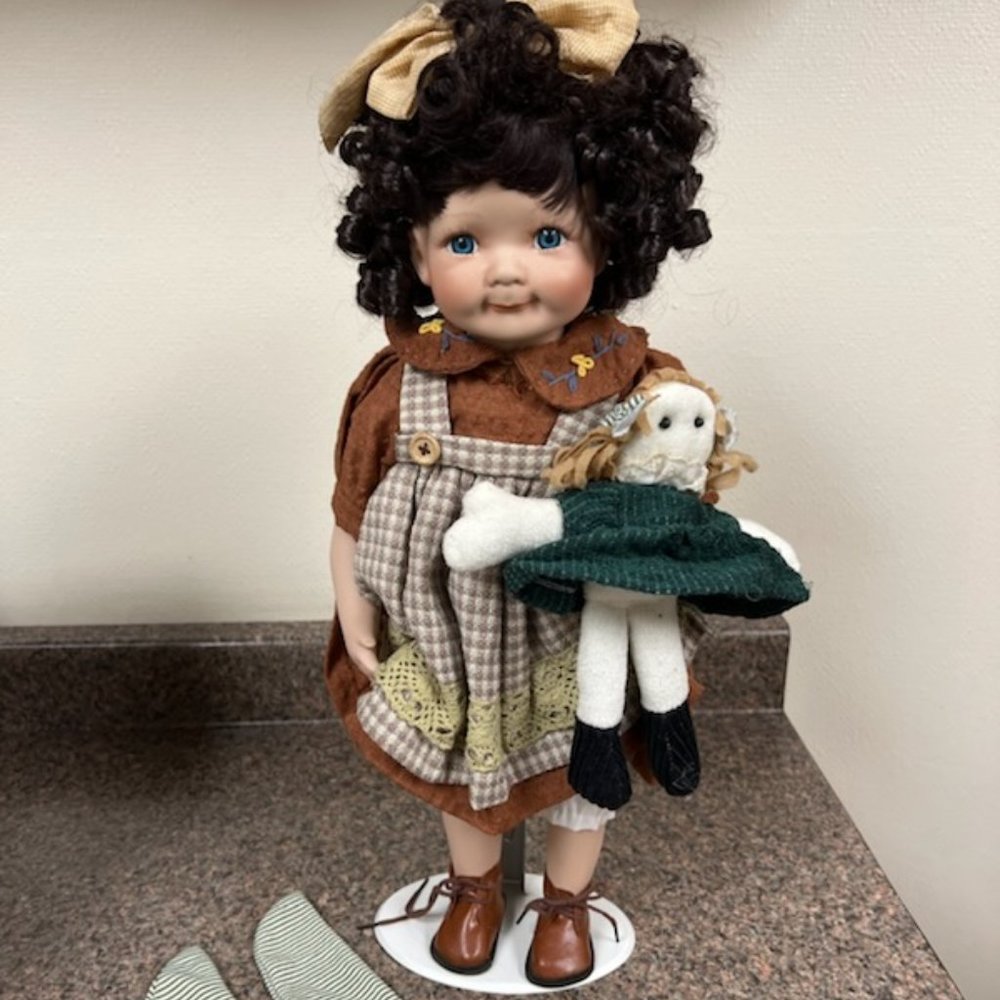 Porcelain doll holding a baby doll